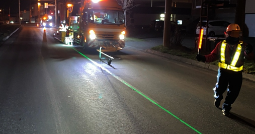 投影したラインパターン(緑の光の線)に沿った施工風景